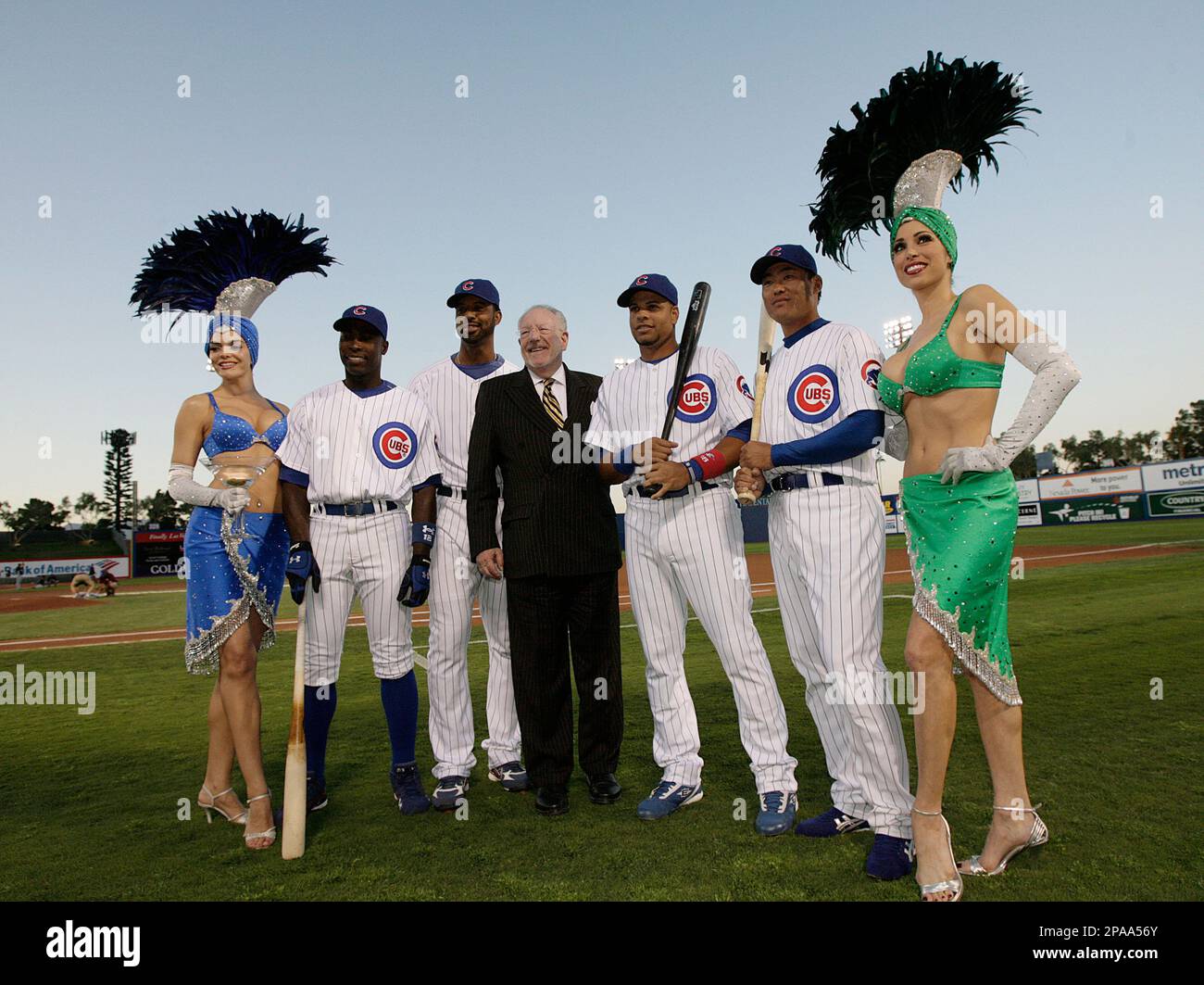 Chicago Cubs' Alfonso Soriano, from second left, Derrek Lee, Las Vegas  Mayor Oscar Goodman, Aramis Ramirez, and Kosuke Fukudome, of Japan, pose  for photos with showgirls before their exhibition baseball game against
