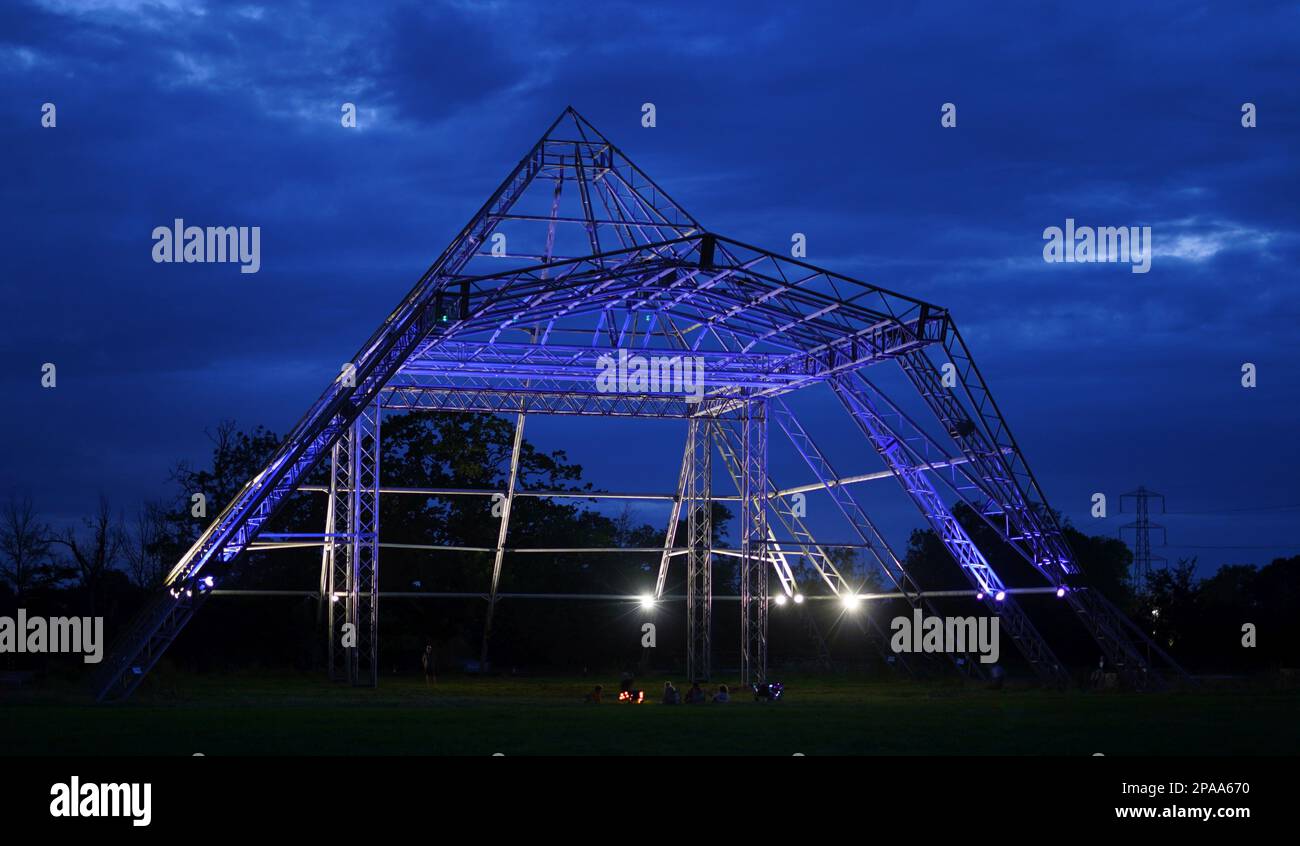 The empty Pyramid Stage at Worthy Farm, Pilton, home of Glastonbury Festival, illuminated at night. Stock Photo