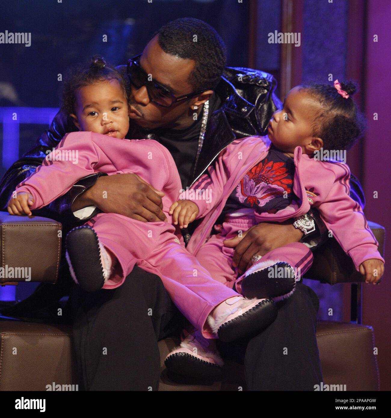 Recording artist Sean 'Diddy' Combs plays with his twin daughters D