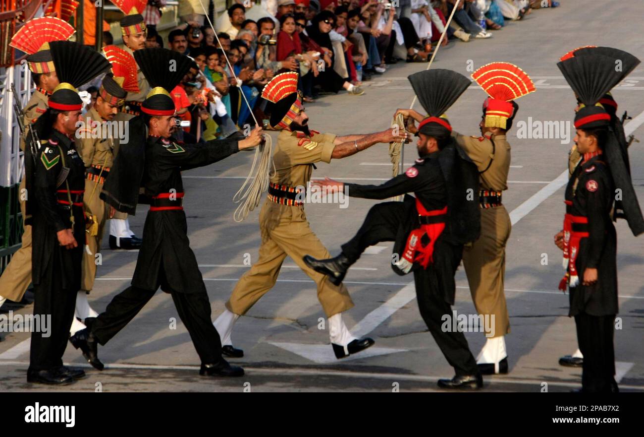 Pakistani Rangers soldiers in black uniform march with their Indian ...