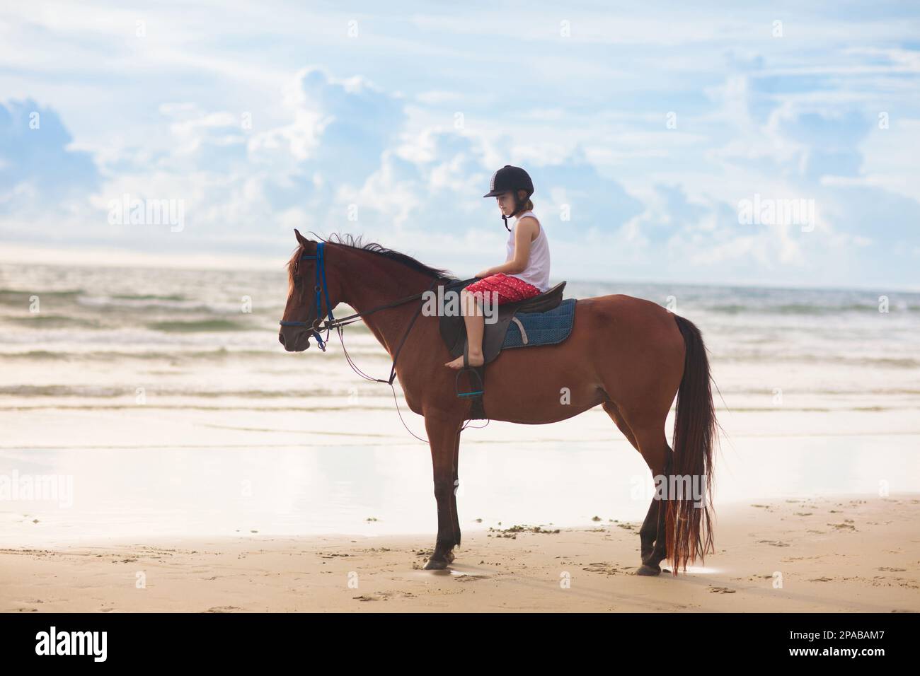 Kids riding horse on beach. Children ride horses. Cute little girl on