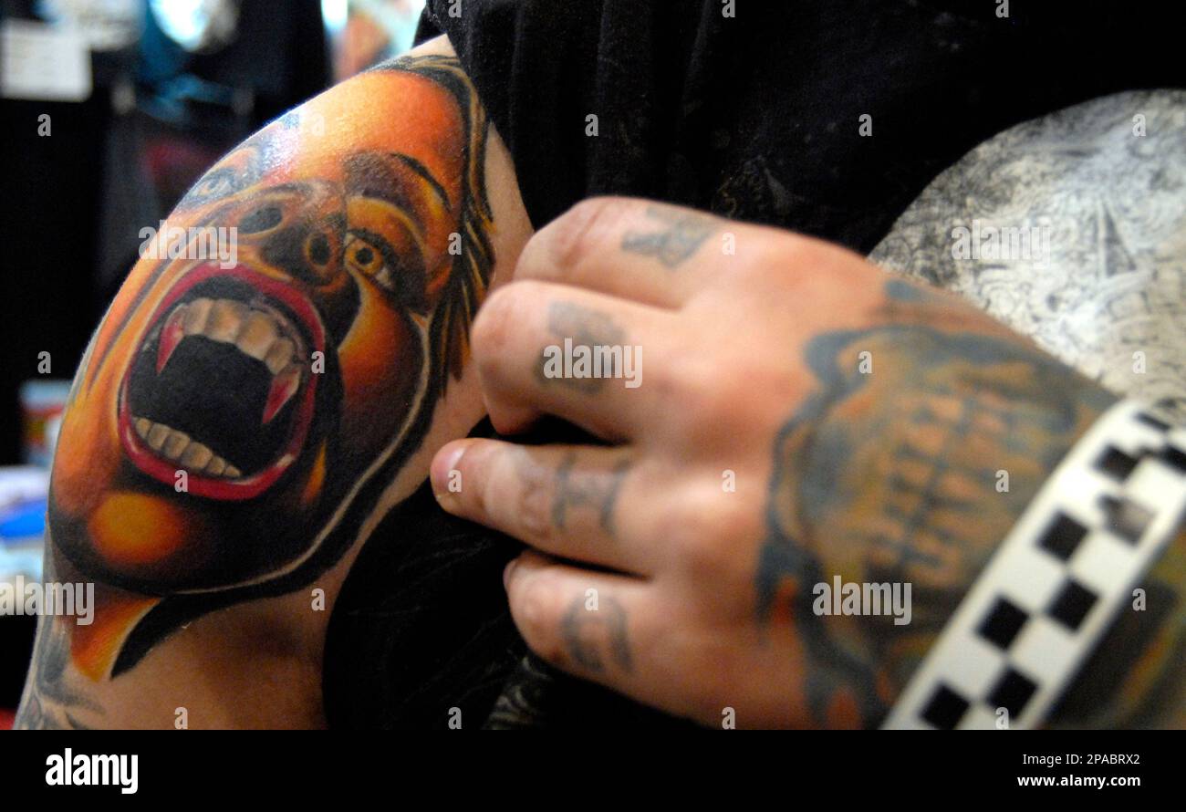 Craig McAlpine of Birmingham, Ala., right, checks out J.D. McGowan's tattoos,  left, Friday, March 14, 2008, during Inksplosion 2008, a tattoo and body  piercing convention at the State House Convention Center through