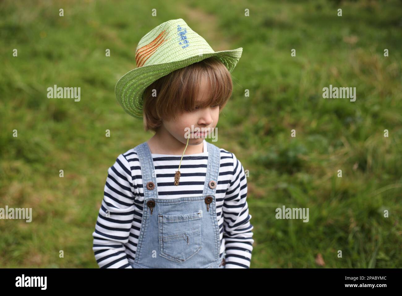 Young child wearing a straw hat Stock Photo