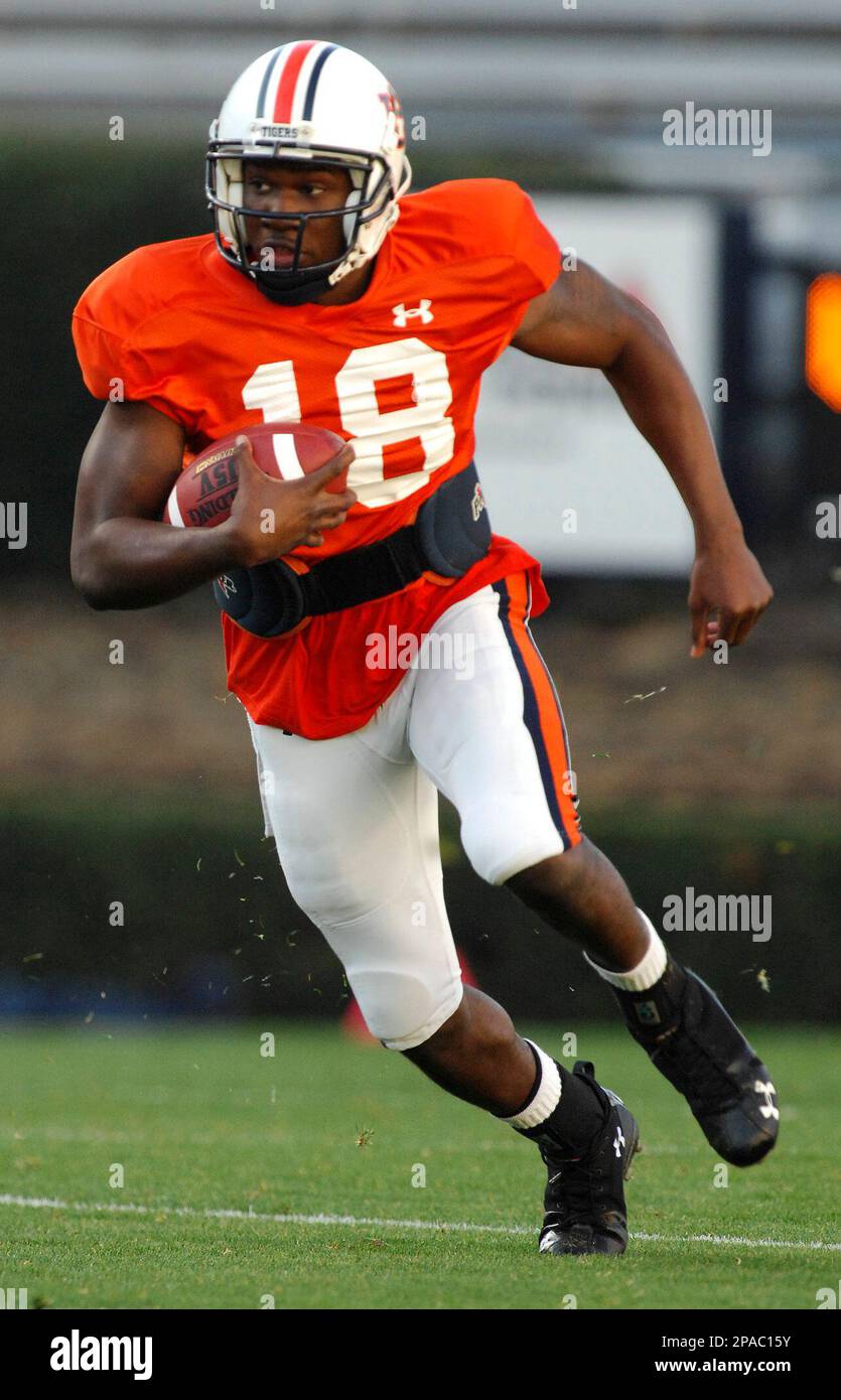 Auburn quarterback Kodi Burns runs from presure during football