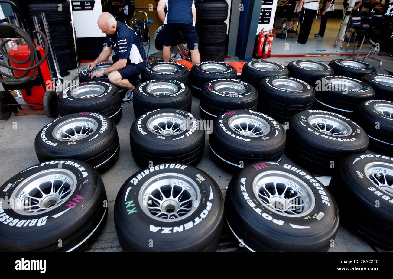 A mechanic from the Williams Formula One team works on the team's tires