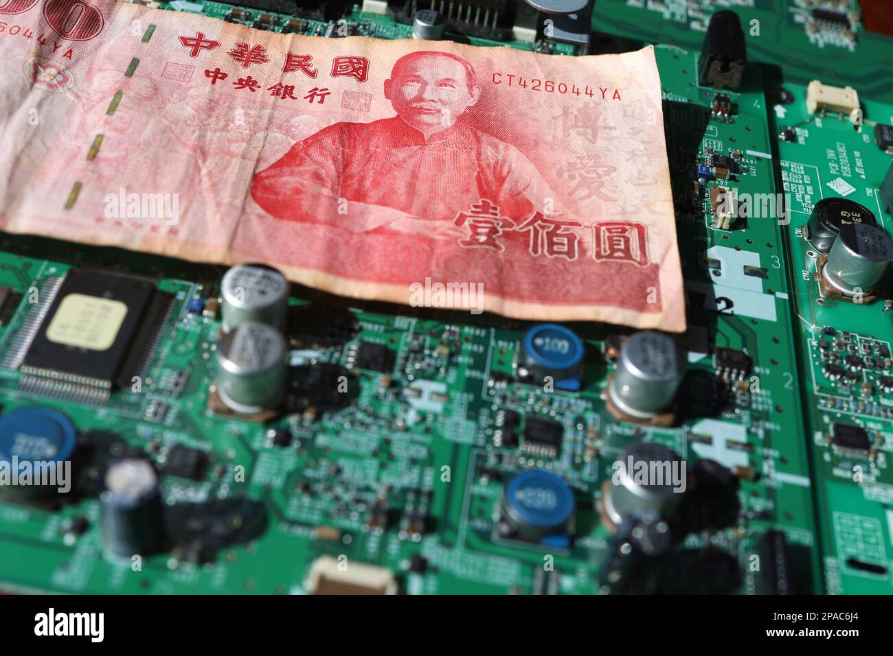 Taiwanese currency and semiconductor printed circuit boards Stock Photo