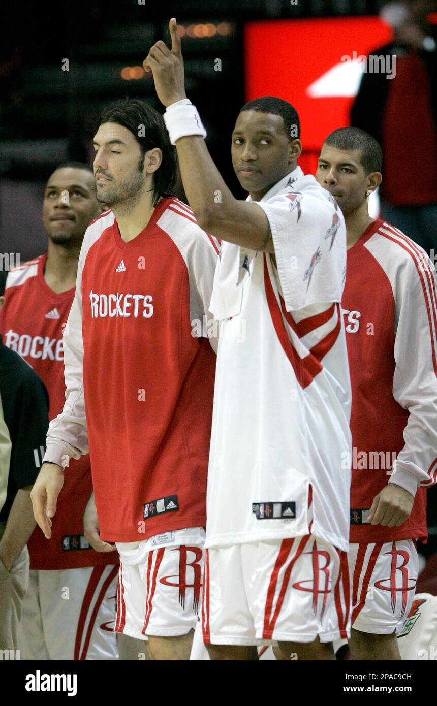 Houston Rockets Tracy McGrady in white puts his finger in the