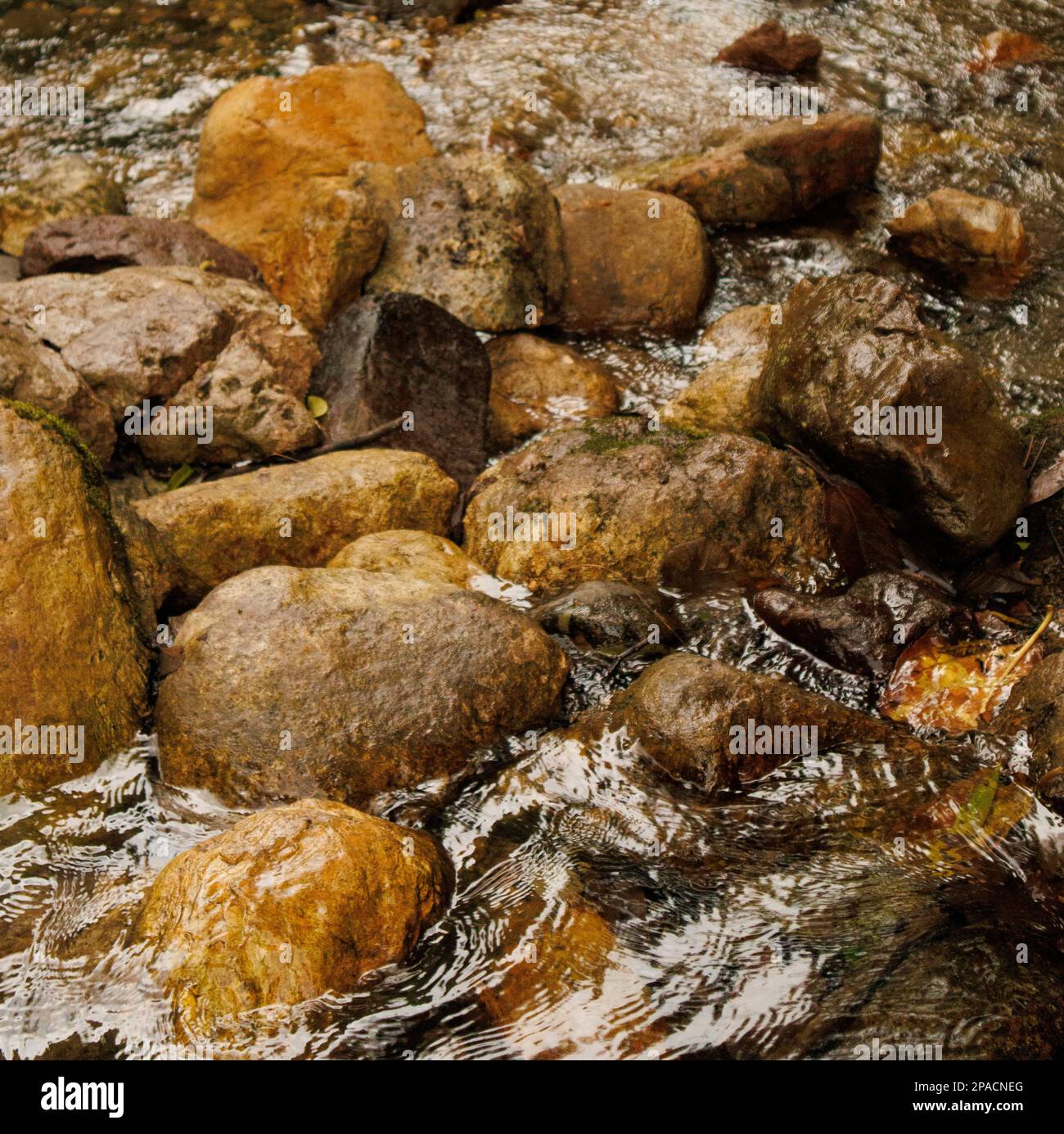 River Parted By Rocks Rocks in the passage of a river Stock Photo - Alamy