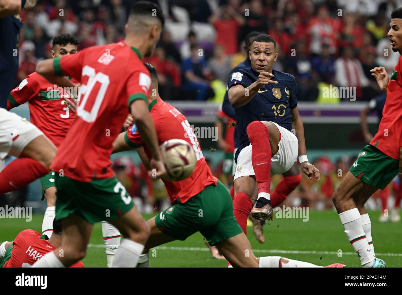 Kylian Mbappé (France) squeezes a pass through five Moroccan defenders in France's 2-0 win over Morocco in the 2022 FIFA World Cup in Qatar. Stock Photo