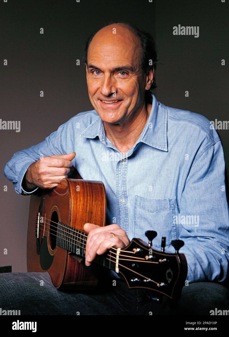 FILE ** Musician James Taylor poses with his guitar Nov. 13, 2007, at the  NBC Studios in Burbank, Calif. James Taylor's CD/DVD set "One Man Band" is  a musical self-portrait that
