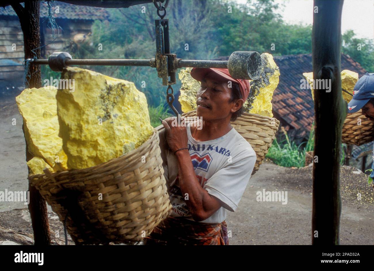 A worker tallies his load of rock sulphur from Ijen Crater, East Java, Indonesia Stock Photo
