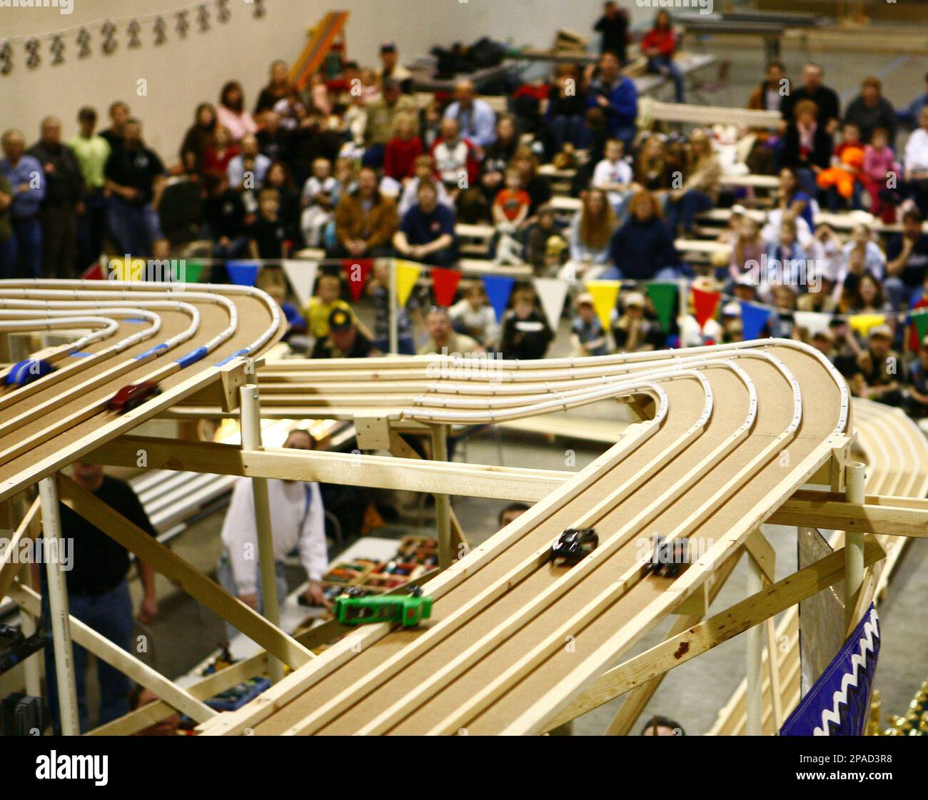 Cars race down what the organizers say is the world’s largest pinewood
