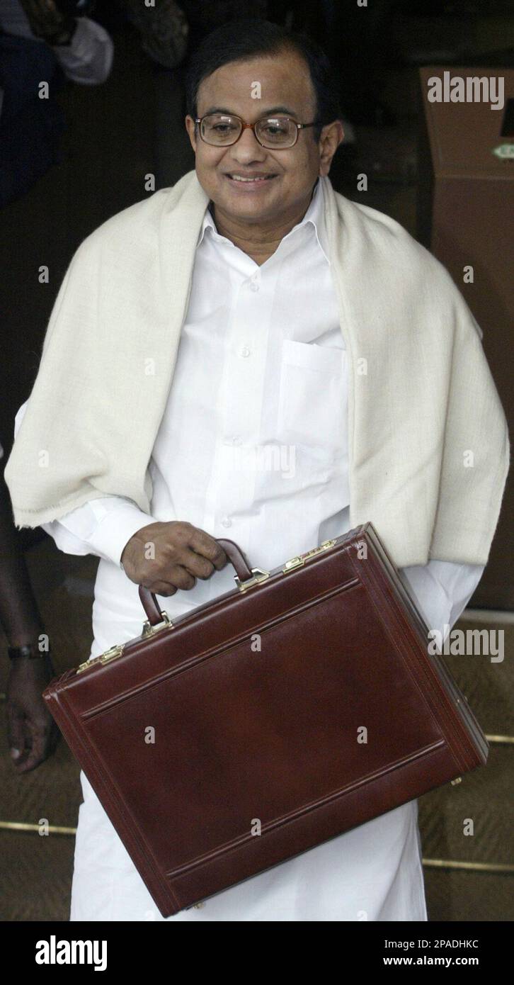 Indian Finance Minister, P Chidambaram, center, poses with the briefcase containing the Union Budget for the financial year 2008-09, before entering Parliament, in New Delhi, India, Friday, Feb. 29, 2008. (AP Photo/Mustafa Quraishi) Stock Photo