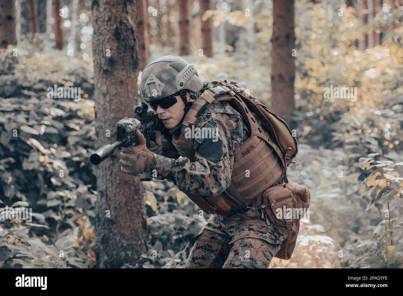 A modern warfare soldier on war duty in dense and dangerous forest ...