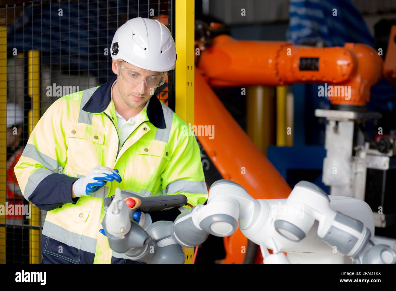 Maintenance Engineer Ropot Young engineer man checking and maintenance machine robot arms ...