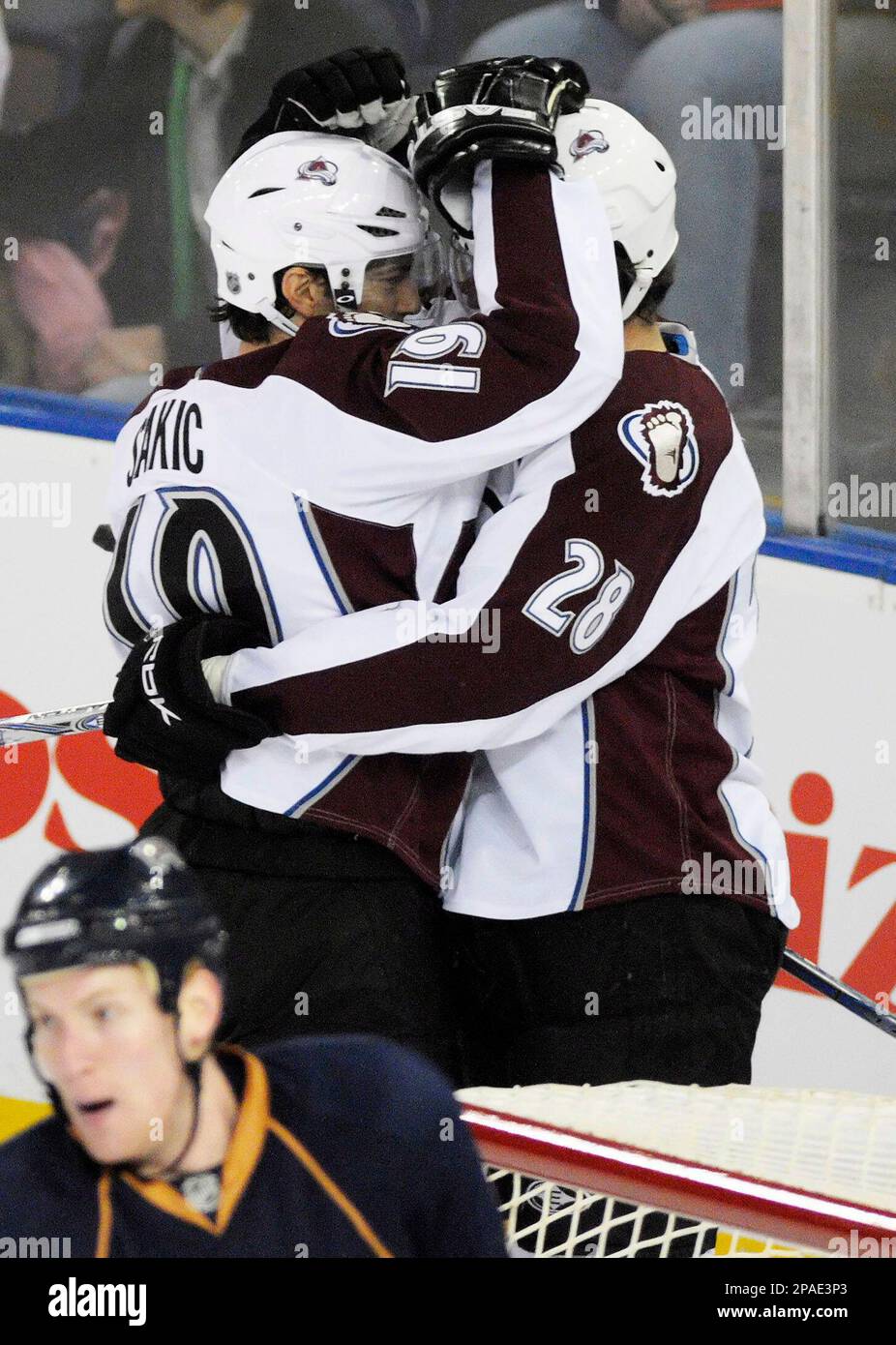 Colorado Avalanche's Joe Sakic, left, is congratulated by teammate Patrice  Brisebois after Sakic scored his second goal against the Los Angeles Kings  in the first period of an NHL hockey game in