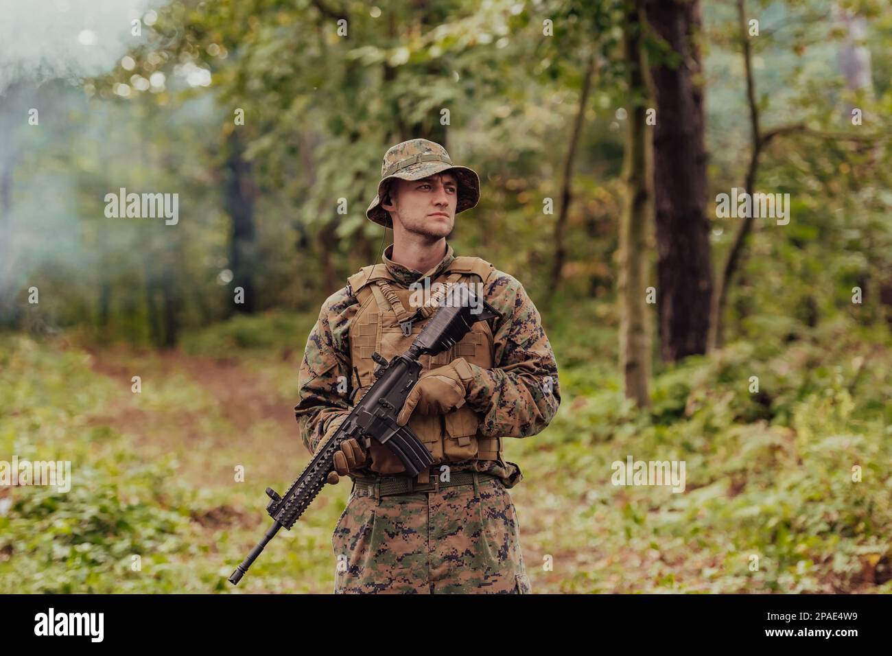 A modern warfare soldier on war duty in dense and dangerous forest ...