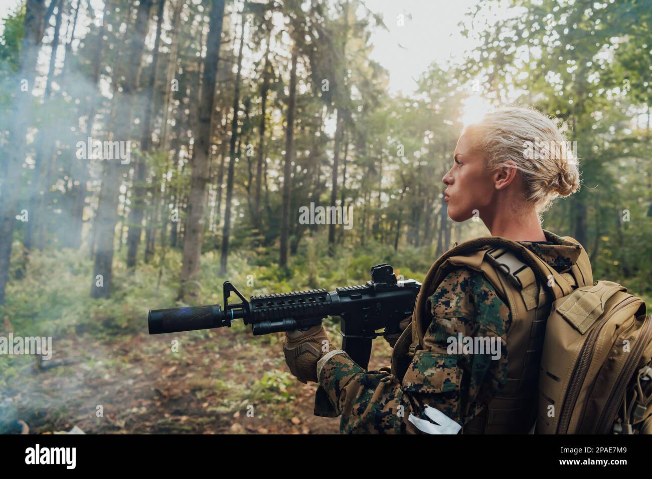 Woman soldier ready for battle wearing protective military gear and weapon Stock Photo