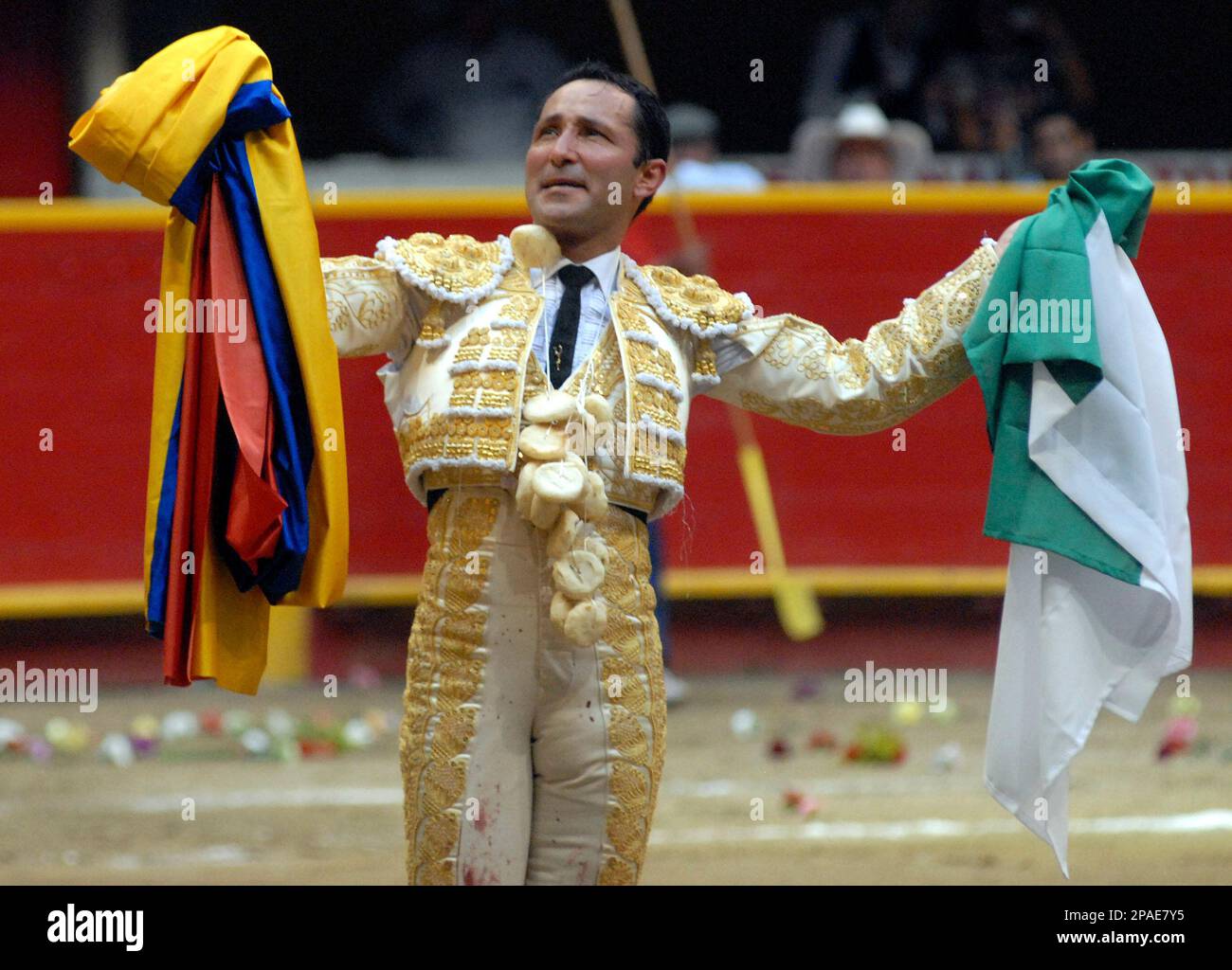 Colombia's bullfighter Cesar Rincon holds a Colombian flag, left, and ...