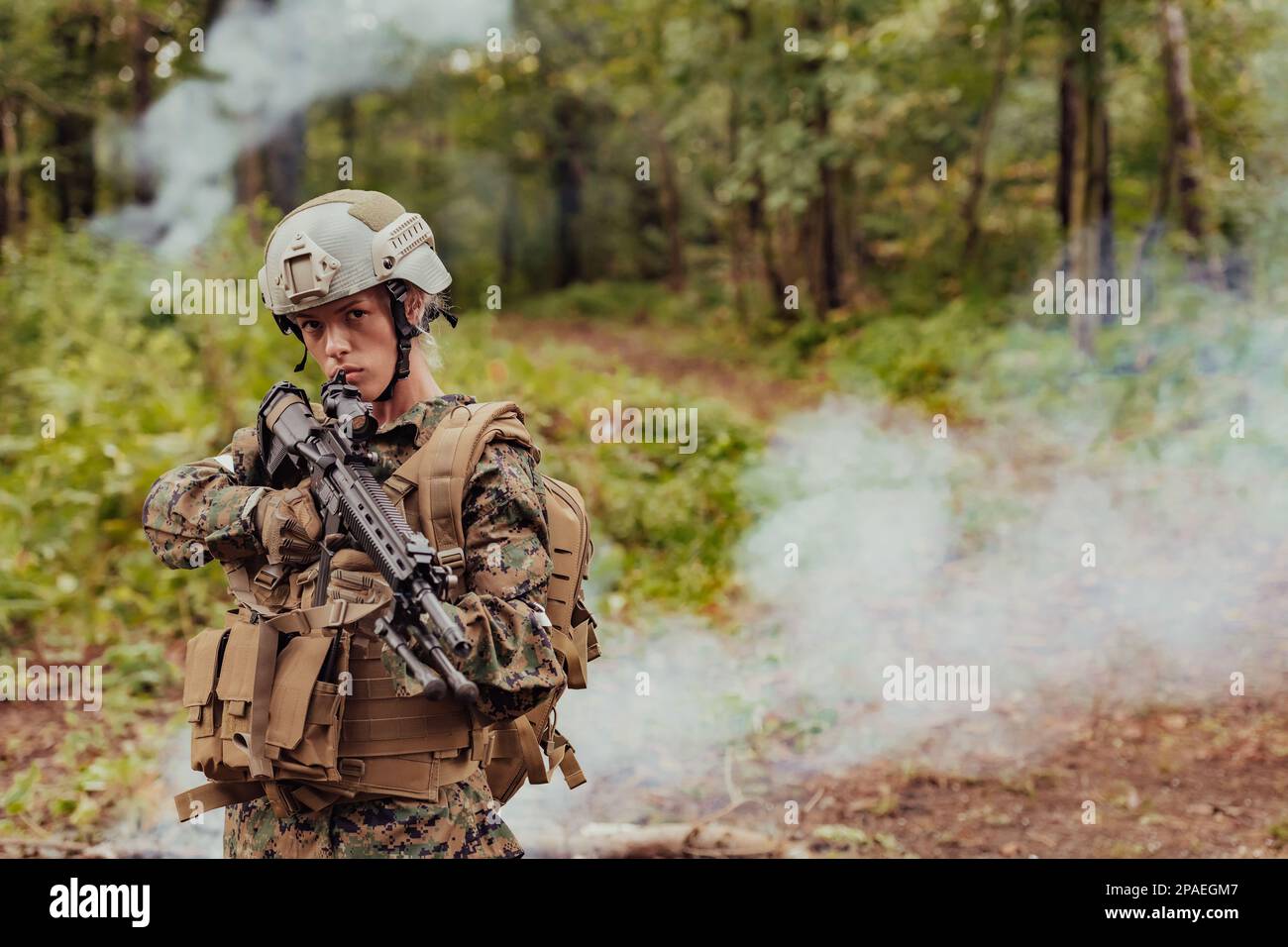 Woman soldier ready for battle wearing protective military gear and