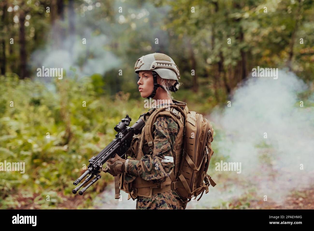 Woman soldier ready for battle wearing protective military gear and