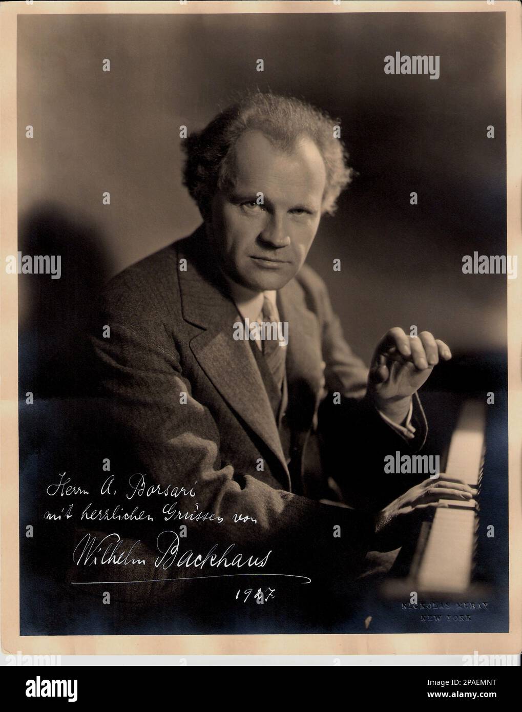 1927  : The german pianist virtuoso WILHELM BACKHAUS ( 1884 - 1969 ), autographed photo dedicated to Bologna musicologist Arnaldo  Borsari  . Photo by Nicholas Muray , New York . Born in Leipzig, Backhaus studied at the conservatoire in Leipzig with Alois Reckendorf until 1899, later taking private lessons with Eugen d'Albert in Frankfurt am Main. He made his first concert tour at the age of sixteen. In 1905 he won the Anton Rubinstein Competition with Bela Bartok taking second place. He toured widely throughout his life - in 1921 he gave seventeen concerts in Buenos Aires in less than three w Stock Photo
