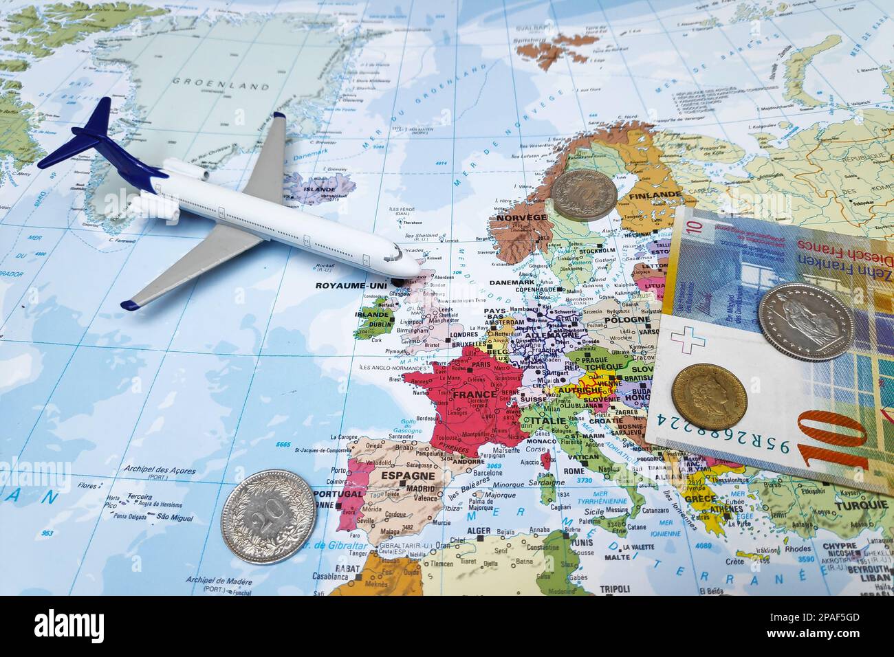 Zurich, Switzerland - February 19 2019: Composition made of a world map centered in Europe with on it, a Swiss Franc banknote and some coins as a toy Stock Photo