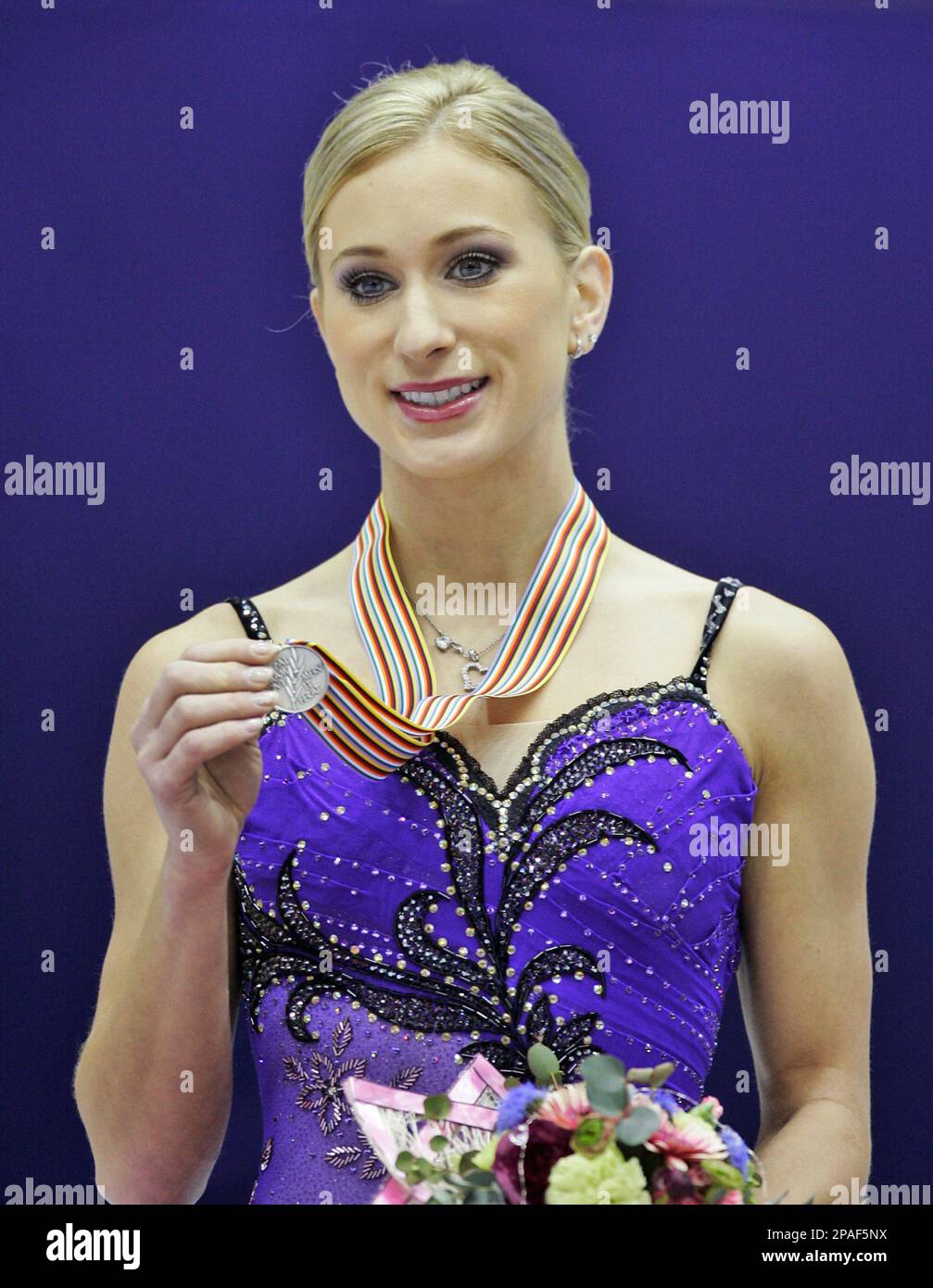 Canada's Joannie Rochette shows off her silver medal during a victory