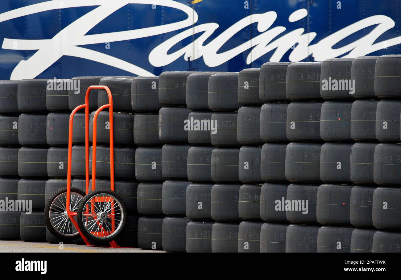 Goodyear racing tires are lineup along the road in the garage area