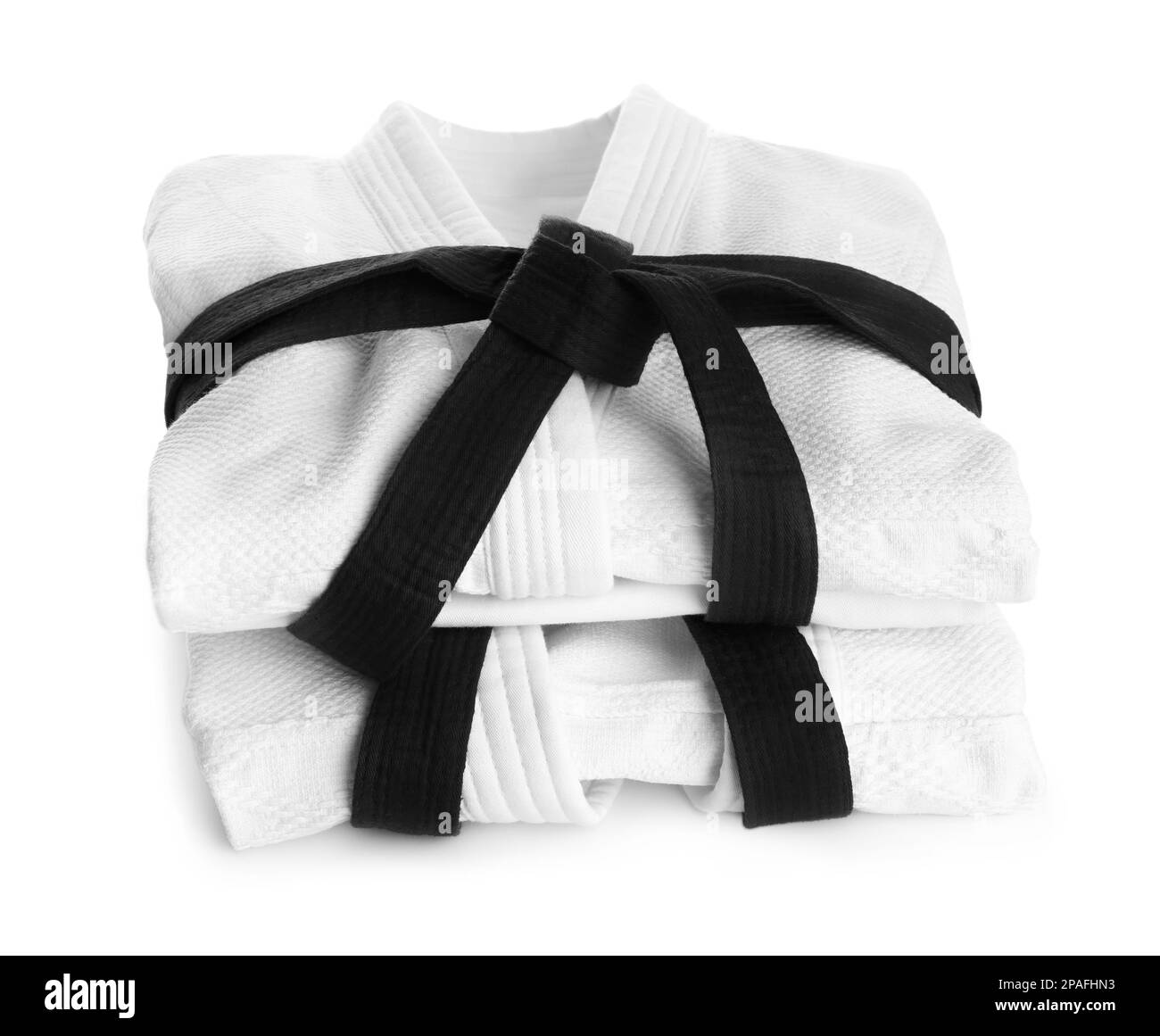 Martial arts uniform with black belts on white background Stock Photo Alamy