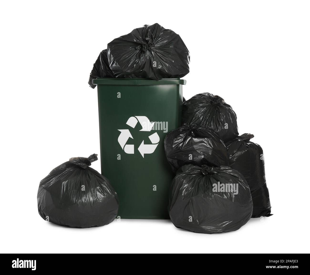 Dark green recycling bin overfilled with garbage bags on white