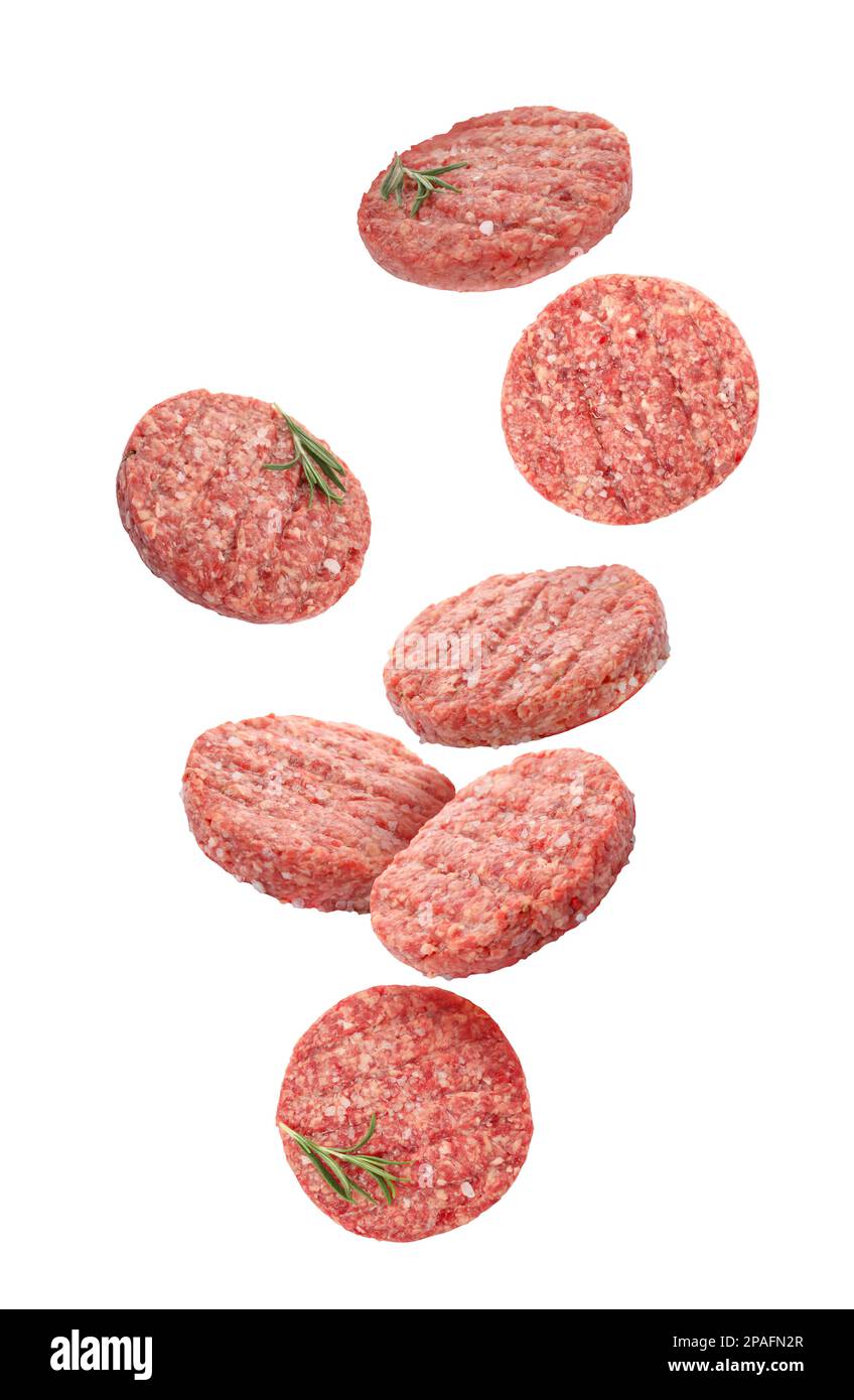 Fresh raw burger patties falling on white background Stock Photo Alamy