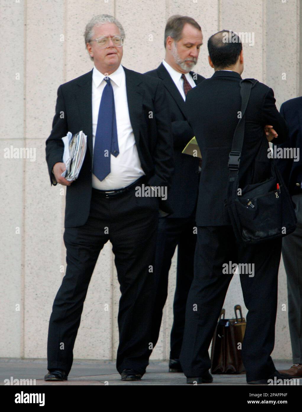 William Lerach, left, waits outside the federal court building Monday