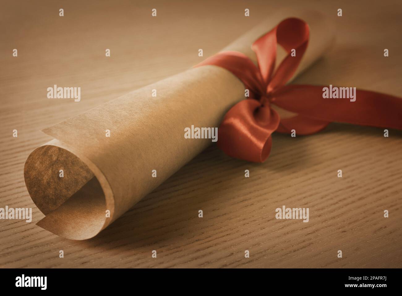 Graduation diploma tied with red ribbon on wooden table, closeup Stock ...