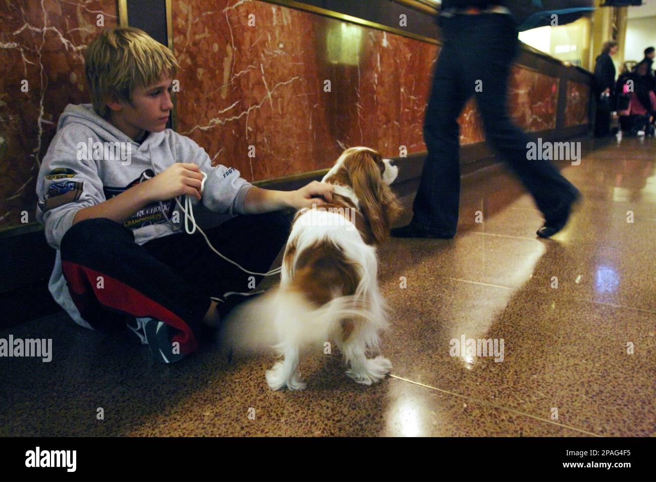 Chance Pippin, 11, of Vacaville, Calif., sits against the checkin