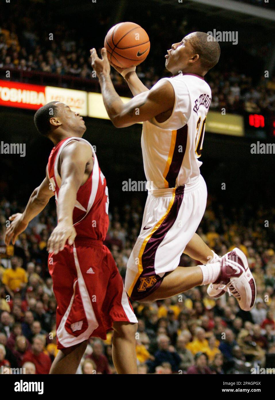 Minnesota guard Lawrence Westbrook, right, shoots over Wisconsin guard