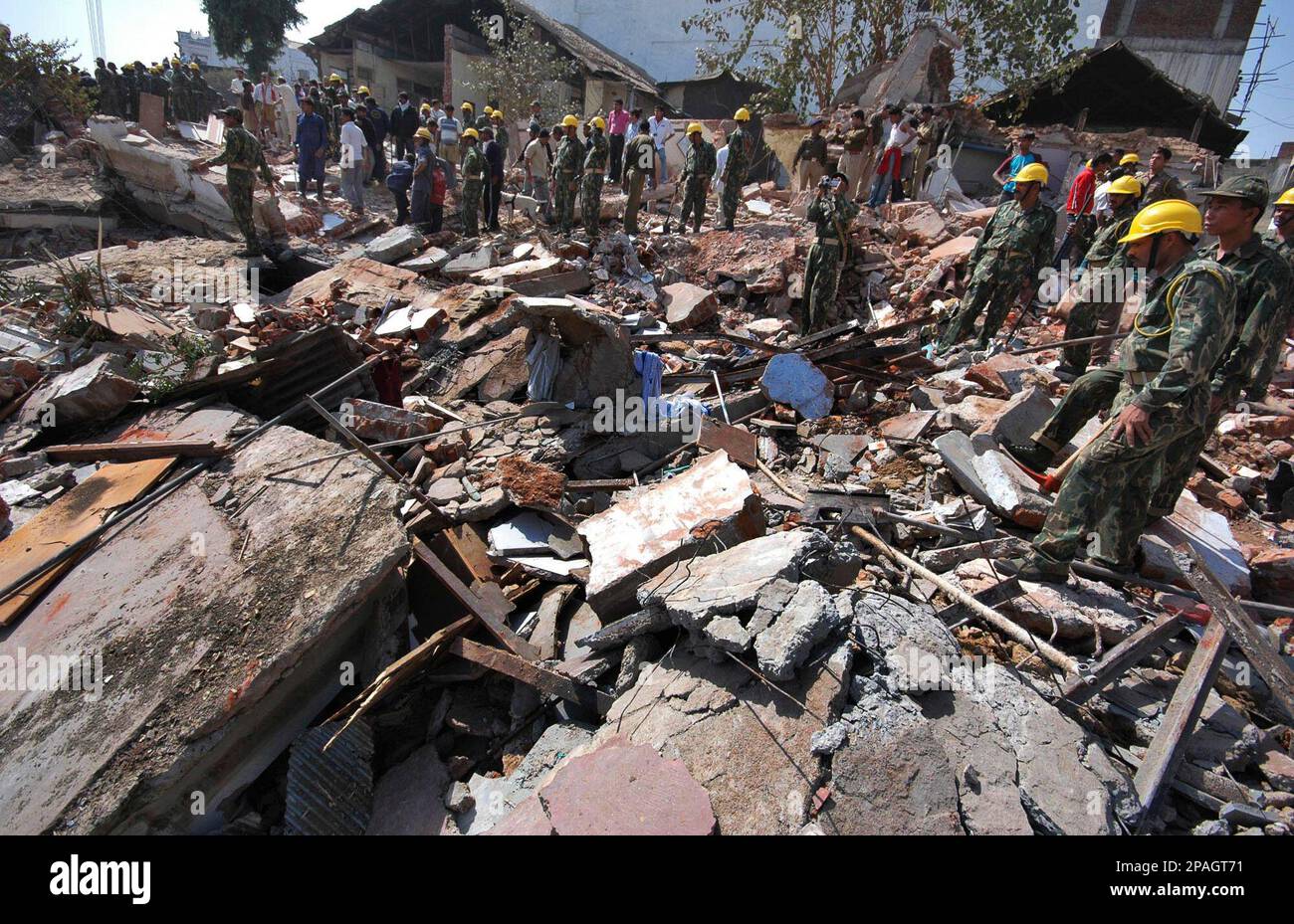 Indian soldiers of Border Security Force scan amidst the rubbles of a ...