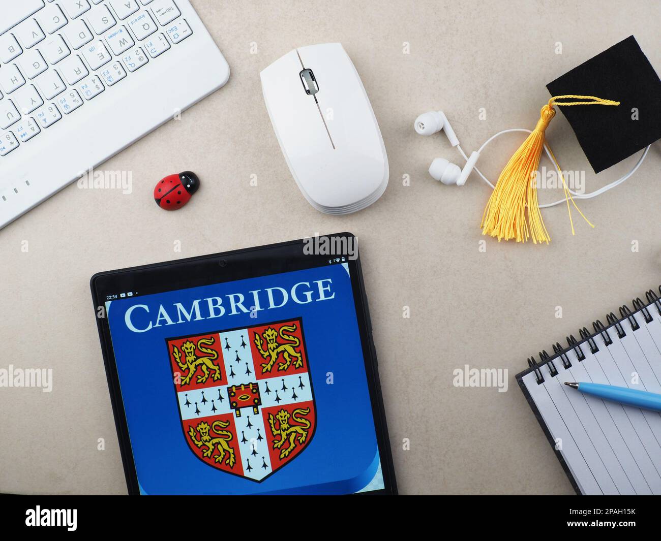 In this photo illustration university of cambridge logo seen displayed