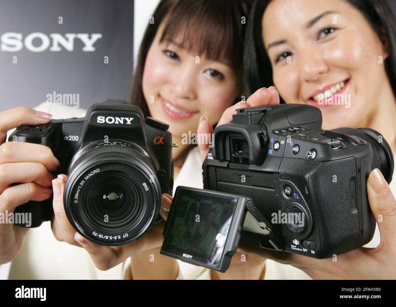 Models show Sony's new digital cameras, alpha 200, left, and alpha 350,  during a press preview in Tokyo Friday, Feb. 1, 2008. The alpha 350 body,  that features a quick auto focus