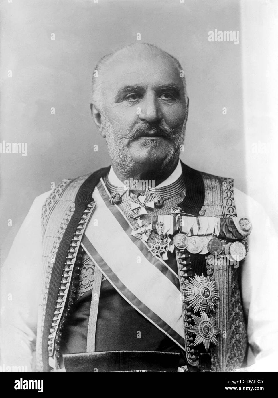 1911 ca. , Montenegro : The King NICHOLAS I of MONTENEGRO ( 1841 - 1921 ) , married with Queen Milena  Vukotic of MONTENEGRO ( 1847 – 1923 ) . Parents of Queen of  Italy ELENA ( Helene of Montenegro , 1873 - 1952 ) . Nicholas was the only king of Montenegro, reigning as king from 1910 to 1918 and as prince from 1860 to 1910. He was also a poet , notably penning ' Onamo, 'namo ' , a popular anthem of Montenegro .- CASA SAVOIA - ITALIA - REALI - NOBILTA' ITALIANA - NOBILITY - ROYALTY - HISTORY - FOTO STORICHE  - BELLE EPOQUE -  RE NICOLA - beard - barba - medals - medaglie - medaglia - baffi - m Stock Photo
