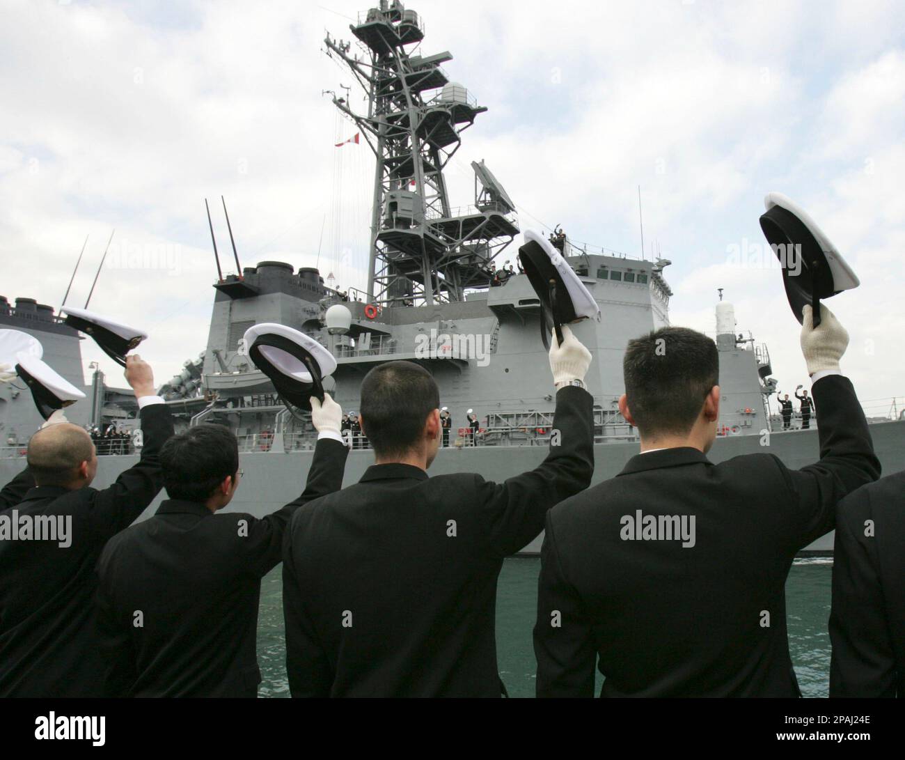 Sailors of the Japan Self-Defense Forces wave their hats as Japanese ...
