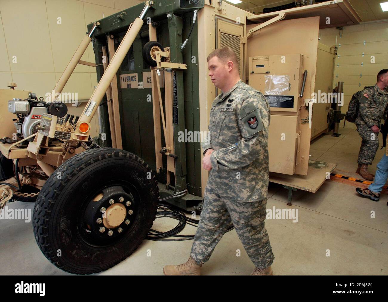 A U.S. Army soldier walks past the Joint Tactical Ground Station, JTAGS