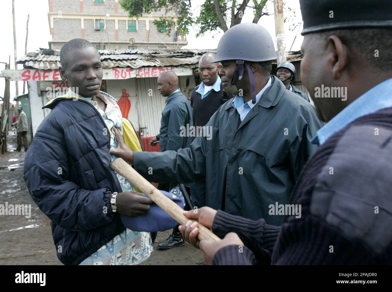 Police officers, left, confront a man during ethnic fighting in the ...