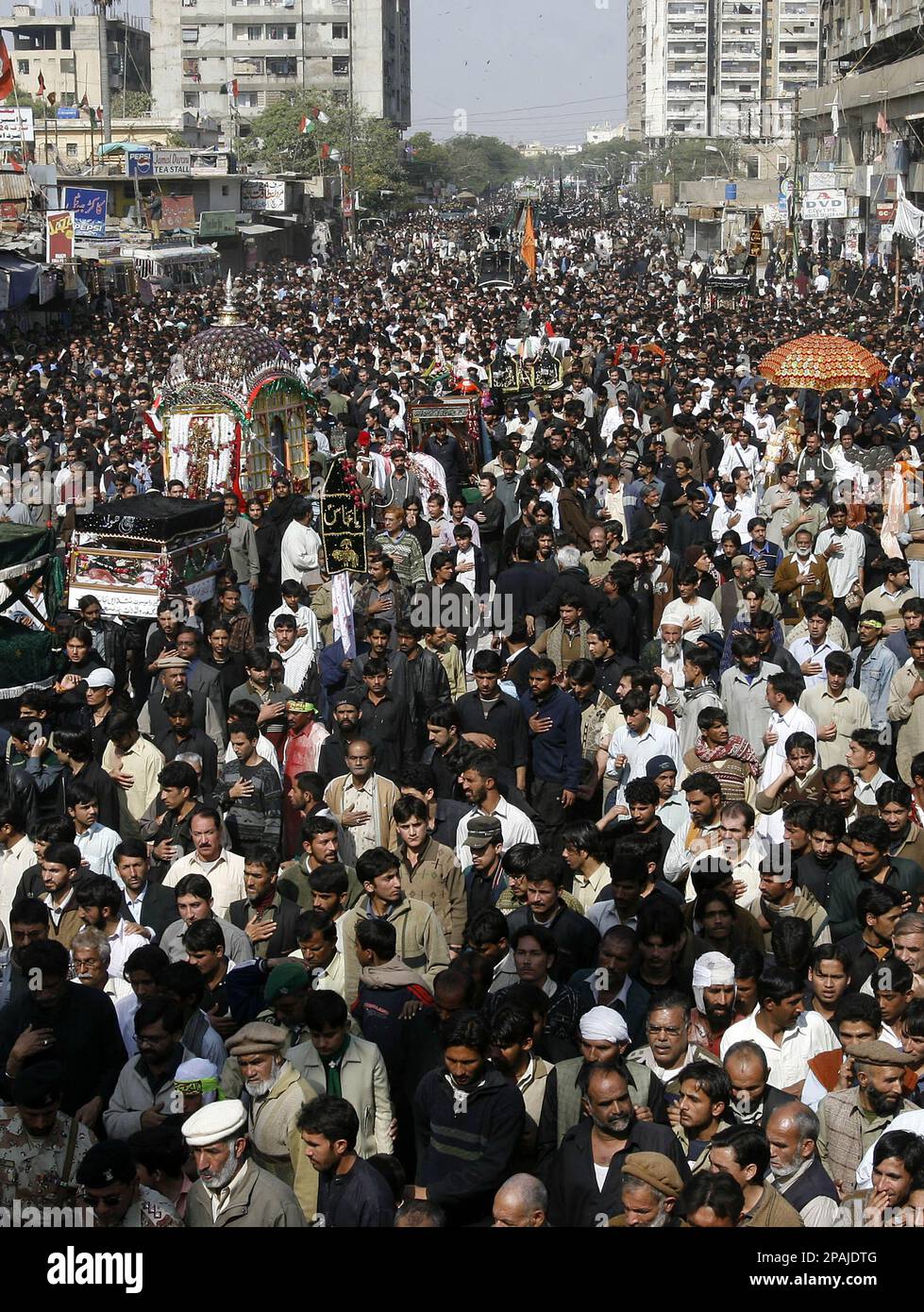 Pakistani Shiite Muslims participate in a procession to mark the Ashura ...