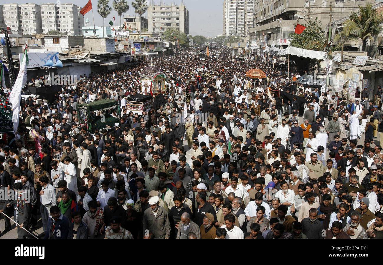 Pakistani Shiite Muslims participate in a procession to mark the Ashura ...