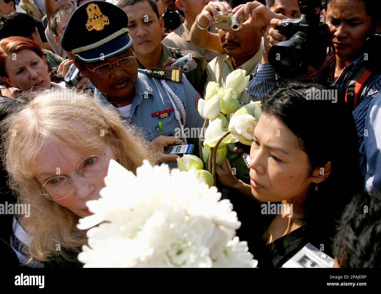 American actress Mia Farrow, left, and Theary Seng, right, Cambodian Executive Director of the Center for Social Development, move away after police pushing their group outside Tuol Sleng genocide museum in Phnom Penh, Cambodia, Sunday, Jan. 20, 2008. Cambodian police blocked Farrow from holding a genocide memorial ceremony Sunday at a Khmer Rouge prison, at one point forcefully pushing her group away from a barricade. (AP Photo/Heng Sinith) Stock Photo