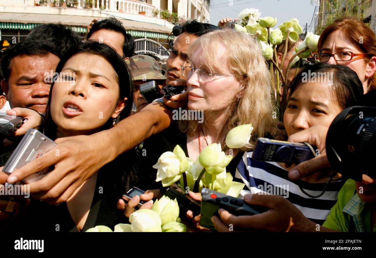American actress Mia Farrow, center, looks on as Theary Seng, second left, Cambodian Executive Director of the Center for Social Development, talks outside Tuol Sleng genocide museum in Phnom Penh, Cambodia, Sunday, Jan. 20, 2008. Cambodian police blocked Farrow from holding a genocide memorial ceremony Sunday at a Khmer Rouge prison, at one point forcefully pushing her group away from a barricade. (AP Photo/Heng Sinith) Stock Photo