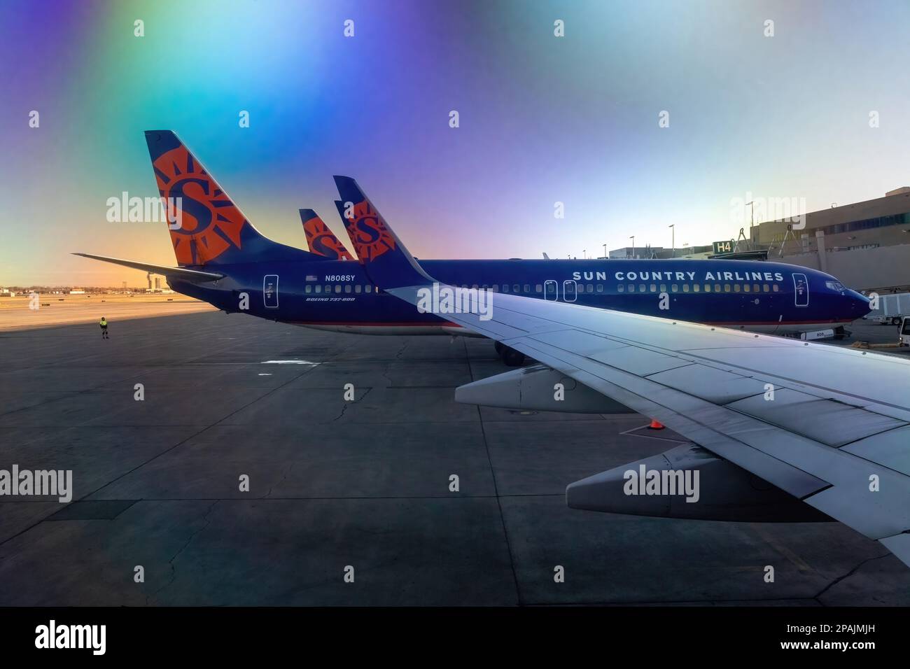Beautiful colors in the sky reflected through the plane window on a Sun Country flight about to