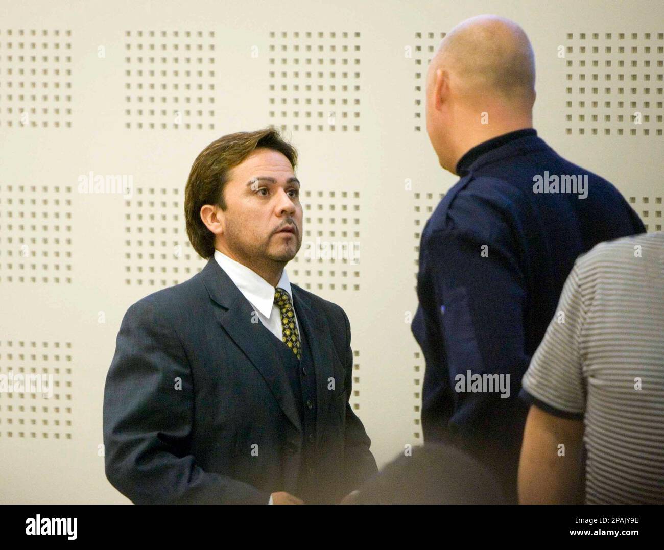 Chilean tenor Tito Beltran, left, talks to an unidentified man during the court hearing in Ystad, Sweden Wednesday Jan. 16, 2008. The 42-year-old opera star, who lives in Sweden, stands trial accused of raping a nanny employed by a Swedish actress in a hotel room in southern Sweden in 1999. (AP Photo/Drago Prvulovic) ** SWEDEN OUT ** Stock Photo