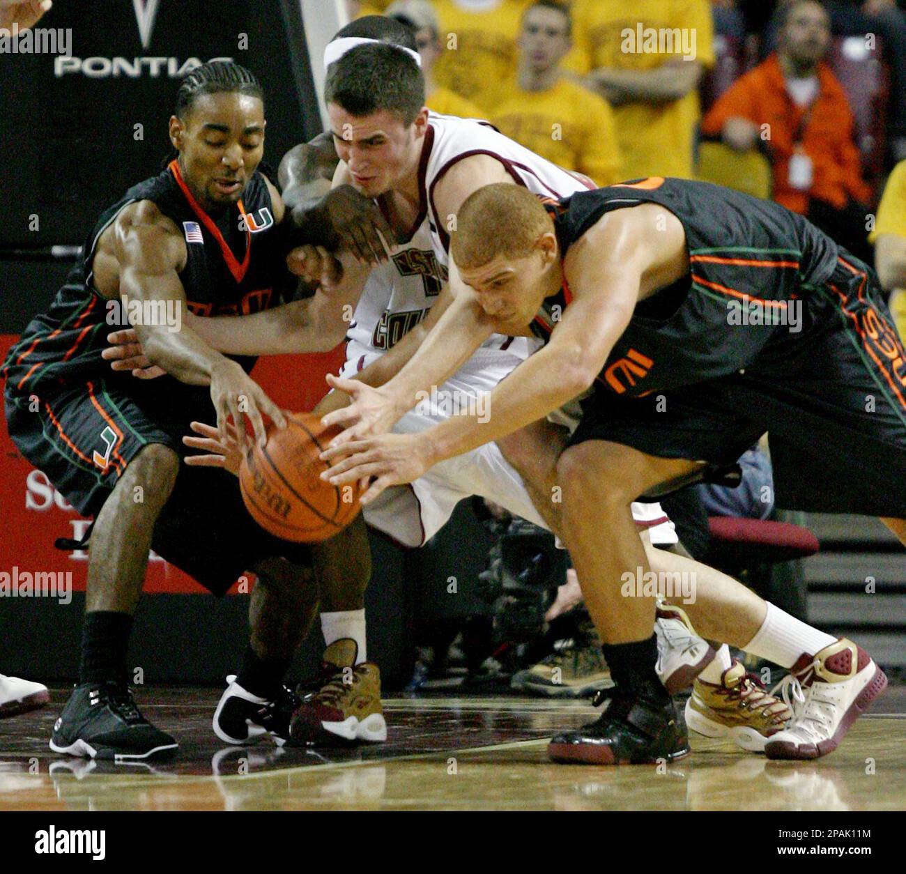 Miami s Lance Hurdle left and Jimmy Graham right and Boston College s Tyler Roche center vie for a loose ball in the second half of a basketball game Tuesday Jan. 15 2008 in